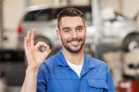 Auto Mechanic Or Smith Showing Ok At Car Workshop Stock Photo By ©syda