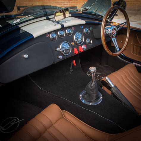 The Interior Of A Classic Sports Car With Leather Seats And Steering