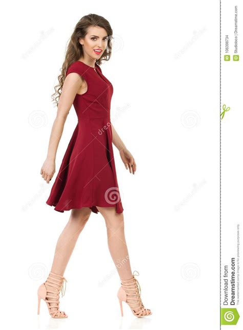 Beautiful Woman In Red Dress And High Heels Is Walking Side View