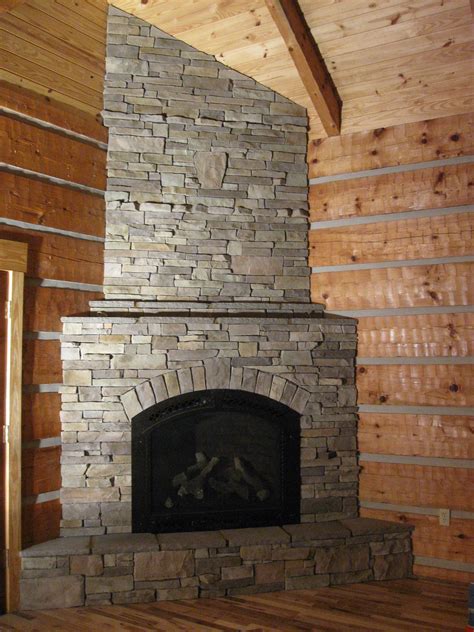 Kitchen has flat panel white painted cabinets, some with glass front doors. Corner fireplace in Stack stone | old barn board ideas ...