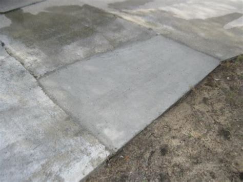 If the top of your driveway meets a structure, like the garage or sidewalk, use an old paintbrush to cut in around the edge. Driveway repair | DoItYourself.com