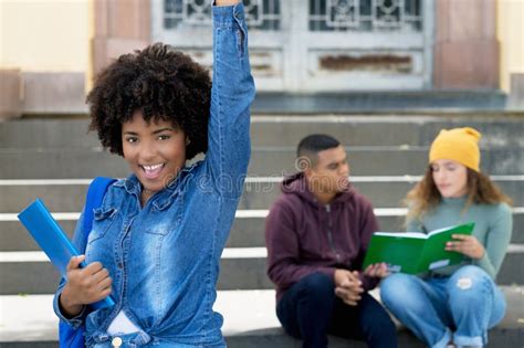 Successful Cheering African American Female Student With Group Of