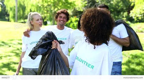 Happy Volunteers Picking Up Trash In The Park Stock Video Footage 4444277