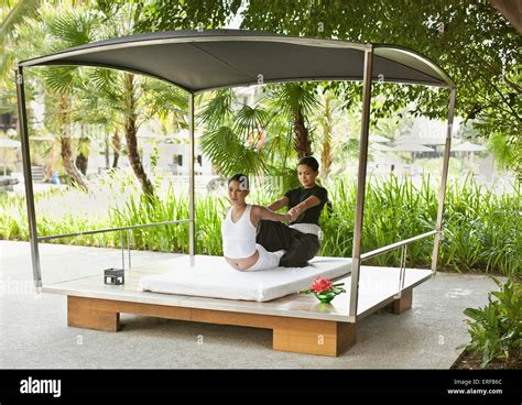 A Woman Receives A Thai Massage In An Outdoor Cabana By The Main Pool