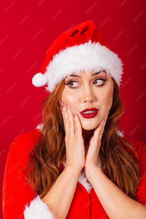 Premium Photo Beautiful Brazilian Redhaired Woman Dressed In Christmas Clothes Santa Claus