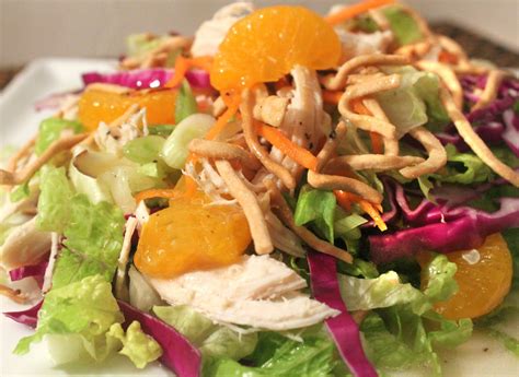 Lightly dressed chinese chicken salad with grilled chicken, crunchy wontons, toasted almonds, and sprinkled with sesame seeds over a crunchy napa cabbage and carrot salad. A Feast for the Eyes: Easy Chinese Chicken Salad, Made Lite