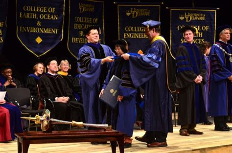 university honors remarkable graduates at doctoral hooding ceremony