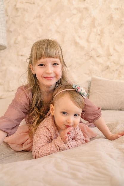 Premium Photo Two Cute Caucasian Sisters In Pink Portrait