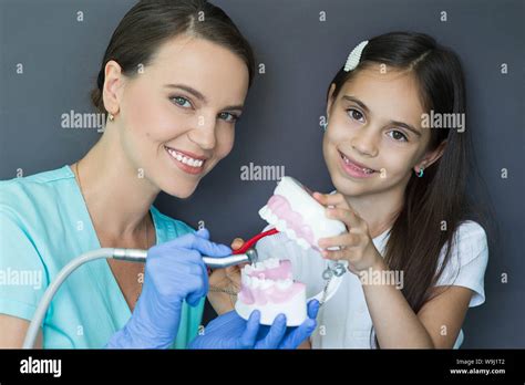 Pediatric Dentist And Mixed Race Little Girl Having Fun With Dental