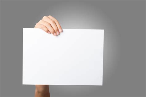 Close Up Of A Woman S Hand Holding Blank Paper Isolated On White