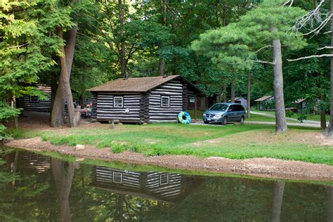 Raccoon creek state park is a recreational demonstration area operated by the national park service since the 1930's. A log cabin is reflected in the fishing pond at Cook Fores ...