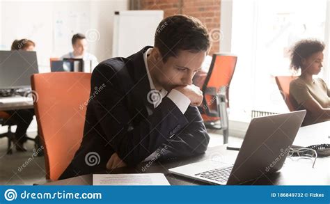 Serious Businessman Employee Using Laptop Working On Difficult Project