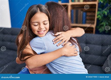 Woman And Girl Mother And Daughter Hugging Each Other At Home Stock