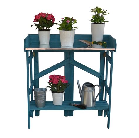Three Potted Plants Sit On A Blue Shelf