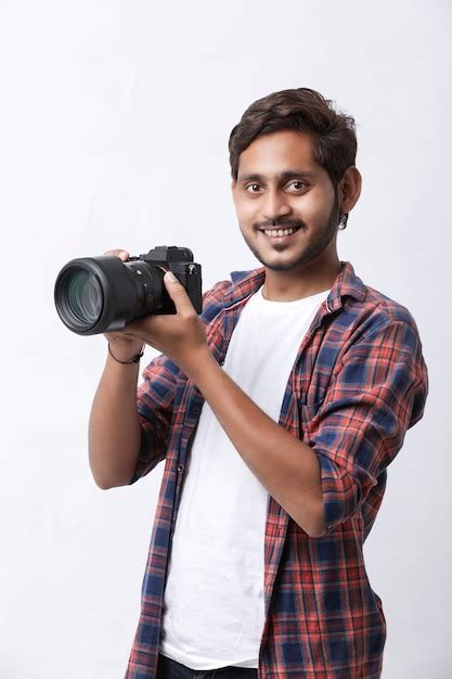 Premium Photo Man In Shirt Holding A Professional Camera