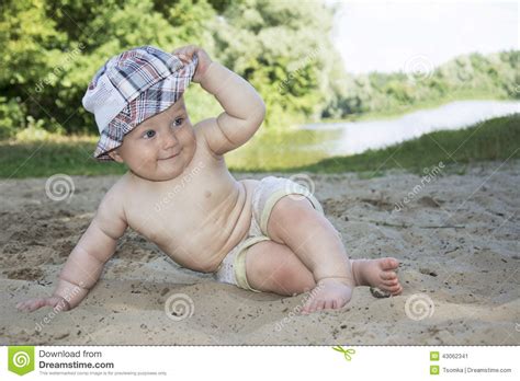 Summertime At The Beach Near The River Sits Funny Little Boy And Stock