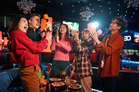group of asian guys and girls singing songs at karaoke club stock image image of indoors