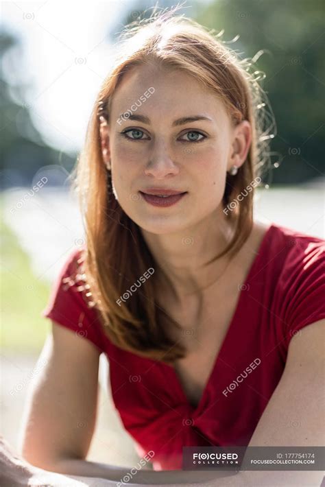Portrait Of Cute Redhead Caucasian Woman Against Blurred Background