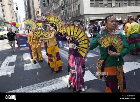 Women In Colorful Costumes Perform And March In The Filipino Parade On