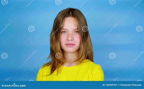 Teen Girl In A Yellow T Shirt Is Looking To The Camera Nods Her Head