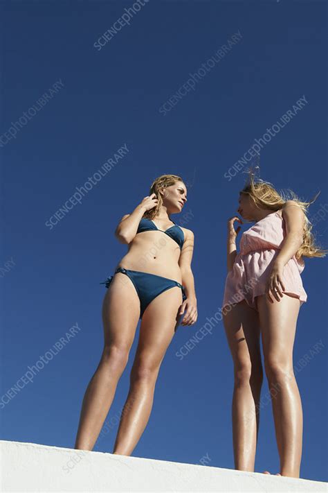 Women Standing On Wall Outdoors Stock Image F Science