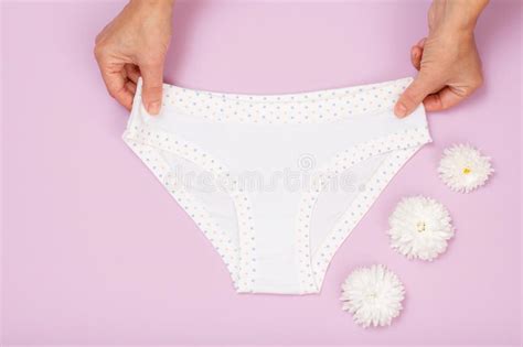 womenand x27 s hands with beautiful panties and sanitary pads on pink background stock image