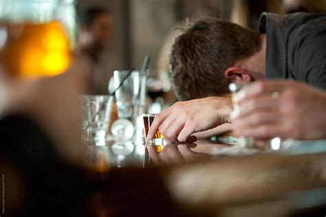 Bar Drunk Passed Out On Bar With Shot Glass By Stocksy Contributor