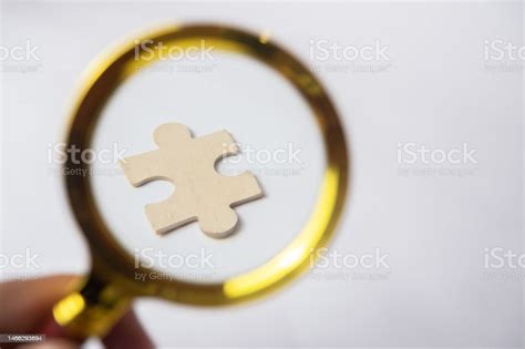 Magnifying Glass Searching For Missing Puzzle Pieces Isolated On White