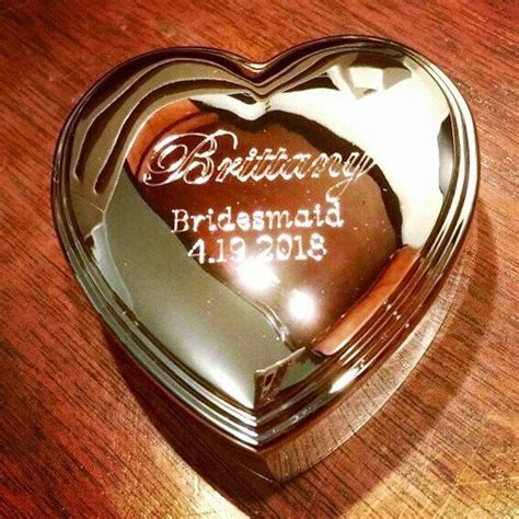 A Heart Shaped Mirror With The Words Bridesmaid In It On A Wooden Table