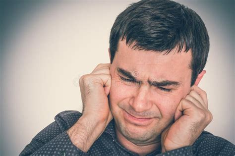 Man Covering His Ears To Protect From Loud Noise Stock Image Image Of
