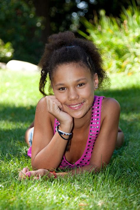 Young Black Teenage Girl Lying On The Grass Royalty Free Stock