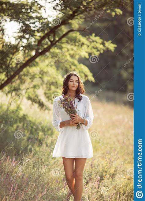 Natural Beauty Girl With Bouquet Of Flowers Outdoor In Freedom