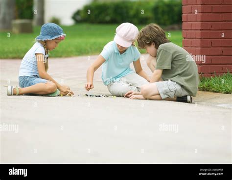 Children Playing Marbles In Street Stock Photo Alamy