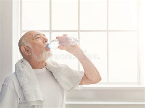 Thirsty Senior Man Drinking Water From Bottle Stock Image Image Of Indoors Dehydration 114582335