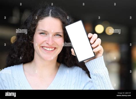 Front View Portrait Of A Happy Woman Showing Blank Cell Phone Screen At