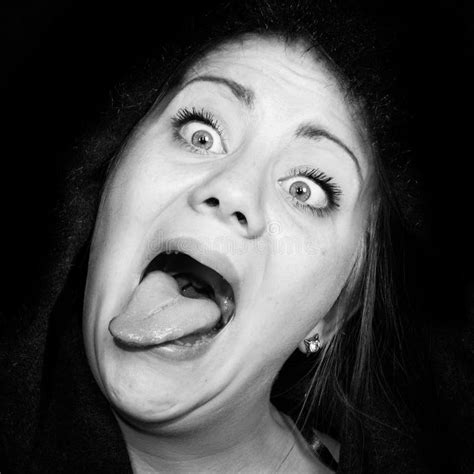 Crazy Woman With Staring Eyes And Outstretched Tongue Stock Photo