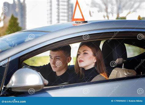 Driving Instructor And Woman Student In Examination Car Stock Photo