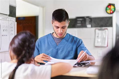 Young Male Nurse Doing Paperwork By Stocksy Contributor Per Images