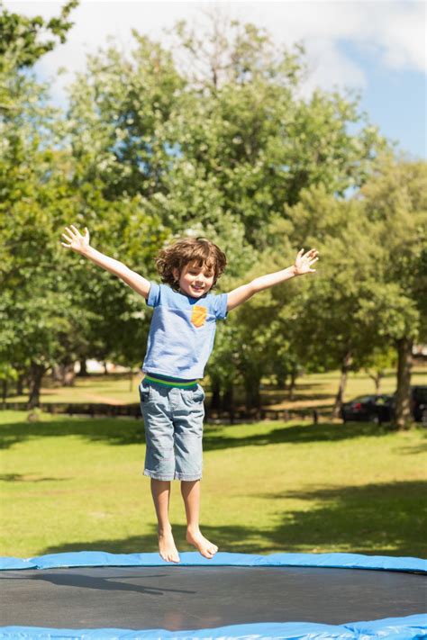 How to jump higher on a trampoline! Happy boy jumping high on trampoline in the park | Premium Photo