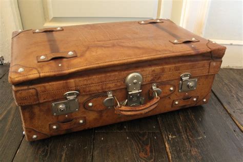 A Large Vintage Tan Leather Suitcase With Chrome Studs 251530