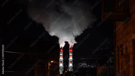 View Of High Smoke Stack With Smoke Emission Two Plant Pipes Pollute