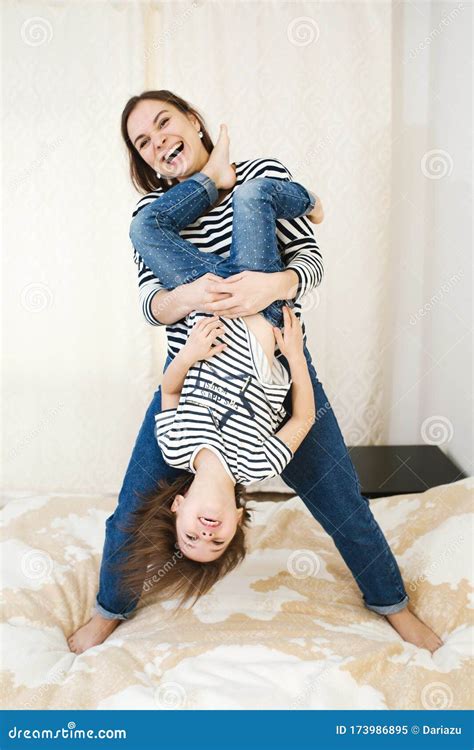 Young Happy Mother Having Fun With Her Cute Little Baby Holding Her