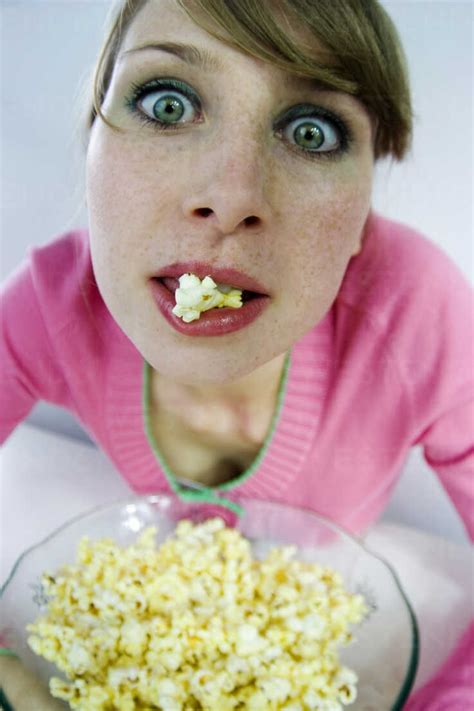 Young Woman Eating Popcorn Portrait Elevated View Stock Photo