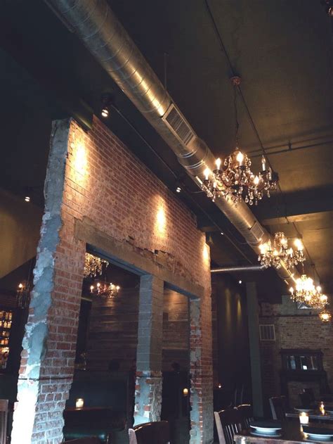 Distressed Brick Tall Ceilings Exposed Duct Work Hanging Chandeliers