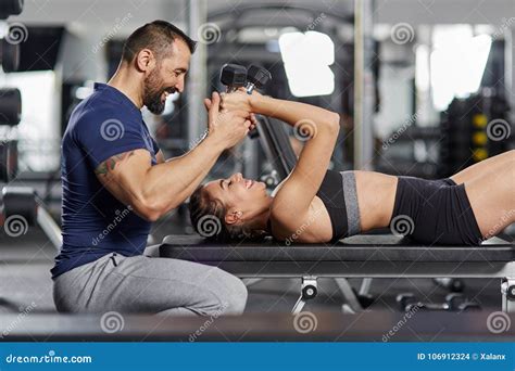 Personal Instructor Assisting Young Woman Stock Photo Image Of Lift
