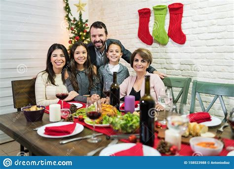 Walk away from the dinner detritus with everyone else. Family During Christmas Dinner Party At Home Stock Photo ...