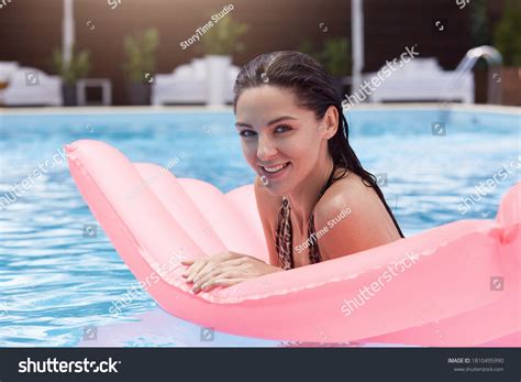 Woman Lying On Water Mattress Swimming Stock Photo