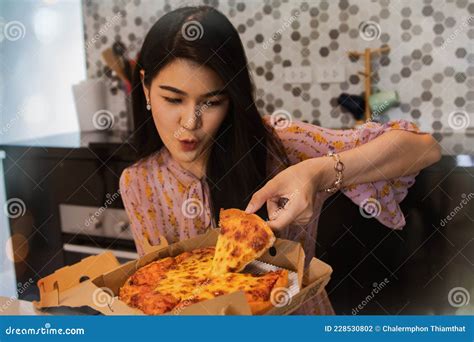 Long Haired Asian Woman Is On A Fat Diet But Loves To Eat Mouthwatering Pizza With Cheese In Her