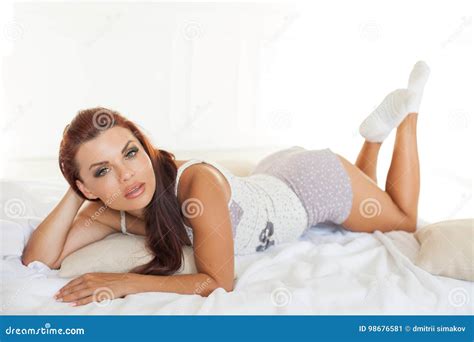 Beautiful Woman In Pajamas Lying On The Bed After Sleeping Stock Image