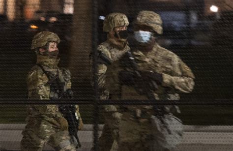 National Guard Troops On Washington Streets Begin Carrying Arms The